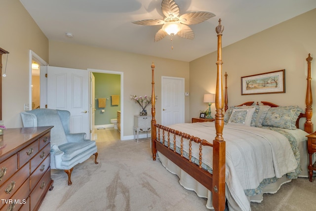 carpeted bedroom featuring ensuite bath and ceiling fan