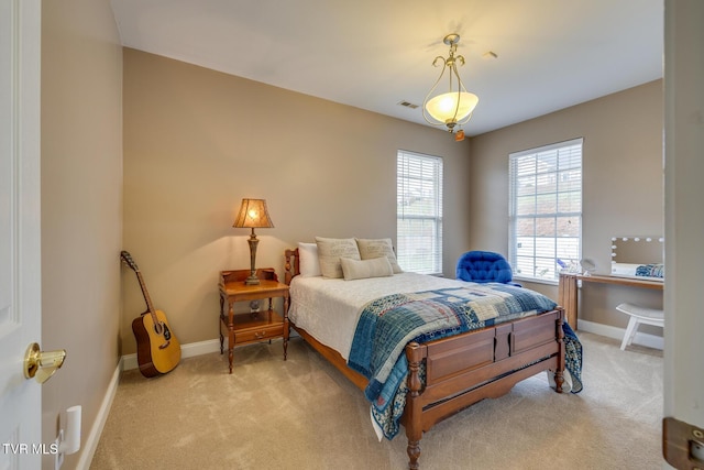 bedroom with light colored carpet