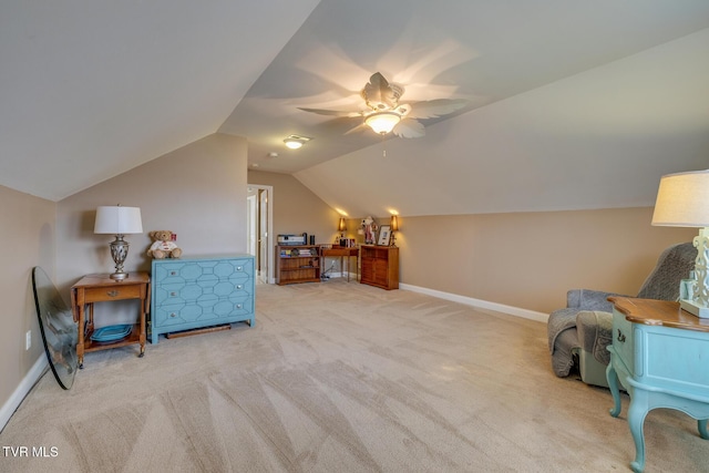 sitting room featuring light carpet, vaulted ceiling, and ceiling fan