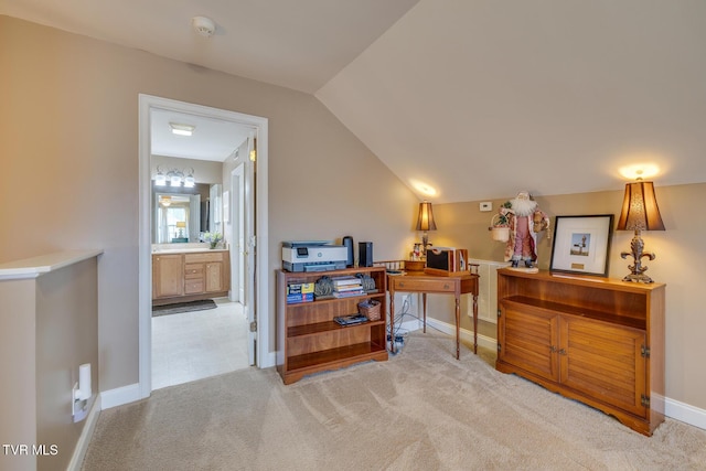 carpeted office with lofted ceiling