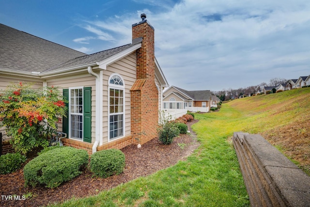 view of side of property with a yard