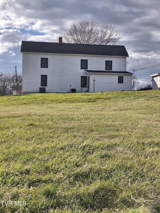 back of house with a yard