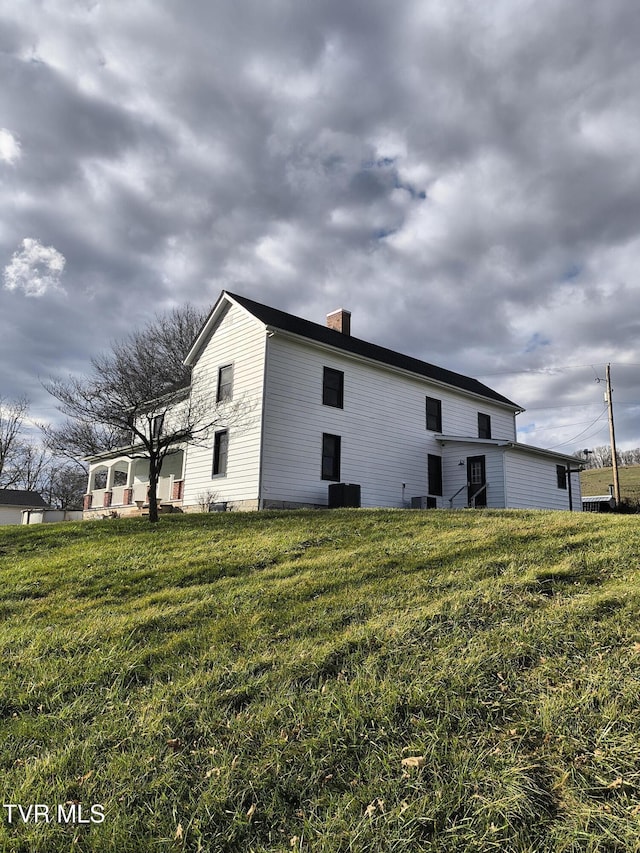 view of home's exterior with a lawn