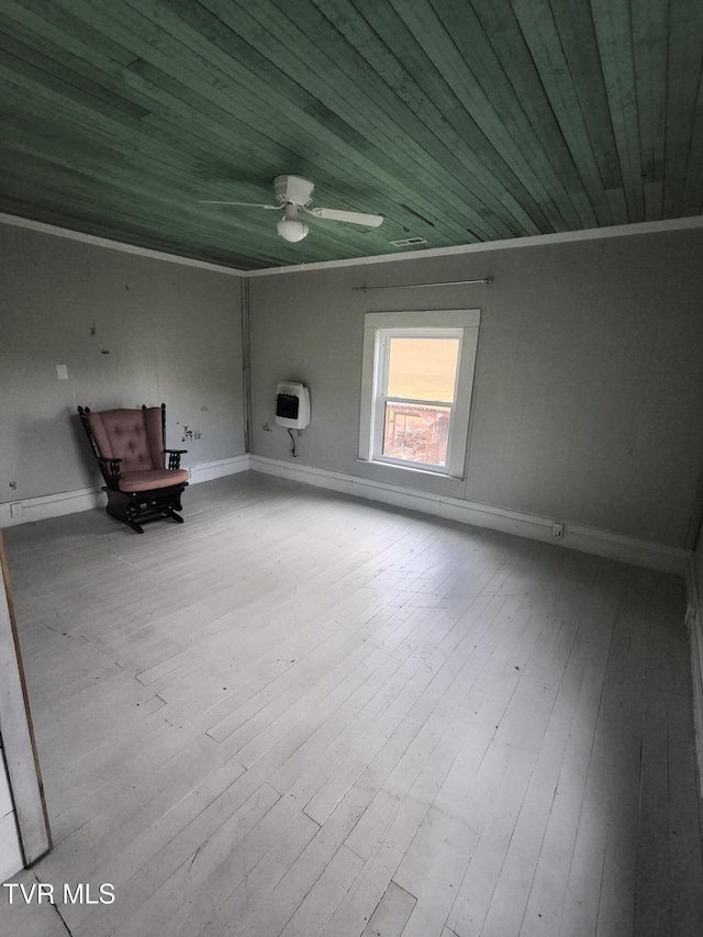 interior space with light wood-type flooring, wooden ceiling, crown molding, and heating unit