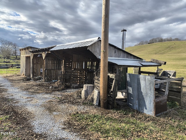 exterior space featuring an outbuilding and a rural view