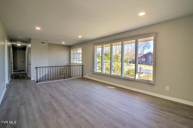 spare room with dark wood-type flooring