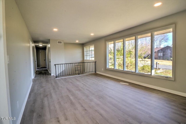 spare room featuring wood-type flooring