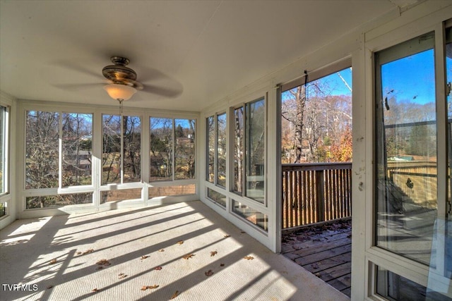 unfurnished sunroom featuring ceiling fan