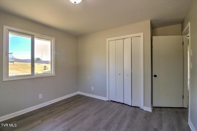 unfurnished bedroom featuring a closet and wood-type flooring