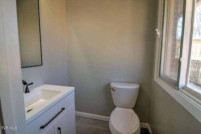 bathroom featuring tile patterned flooring, vanity, and toilet