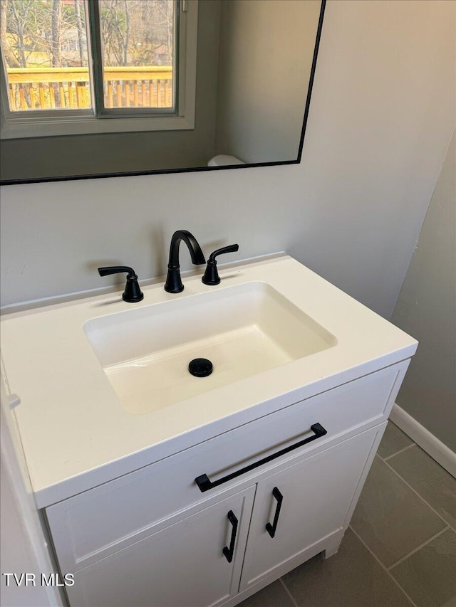 bathroom with tile patterned floors and vanity