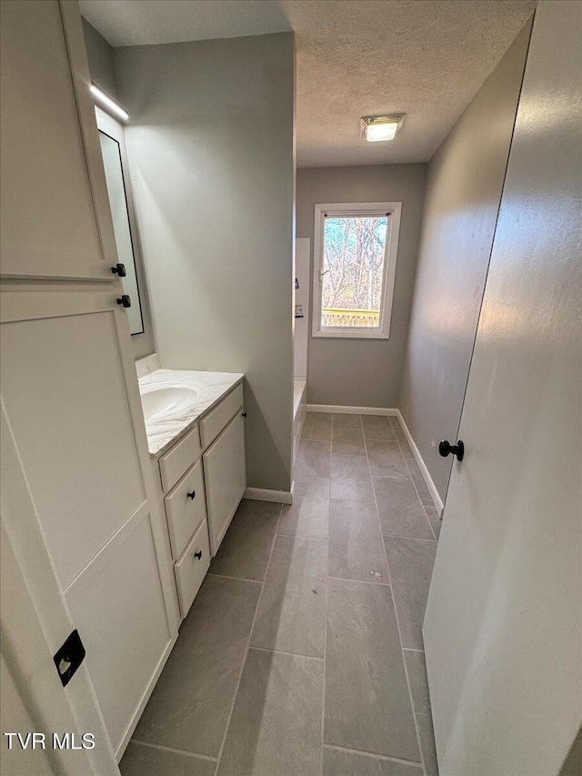 bathroom featuring vanity and a textured ceiling