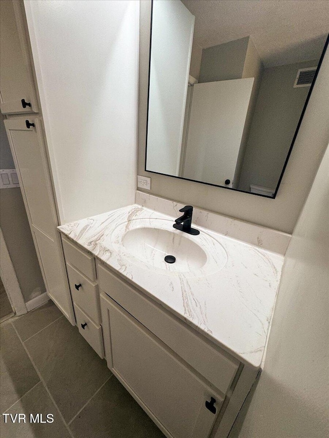 bathroom with vanity and tile patterned floors