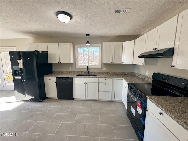 kitchen with black appliances, white cabinetry, sink, and hanging light fixtures