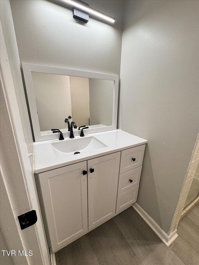 bathroom with vanity and hardwood / wood-style flooring