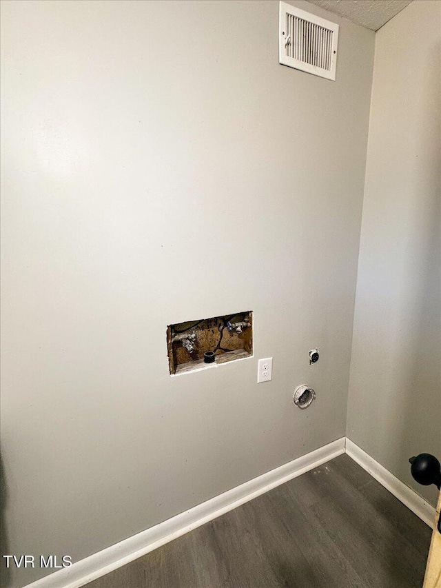 laundry area featuring hookup for an electric dryer and dark wood-type flooring