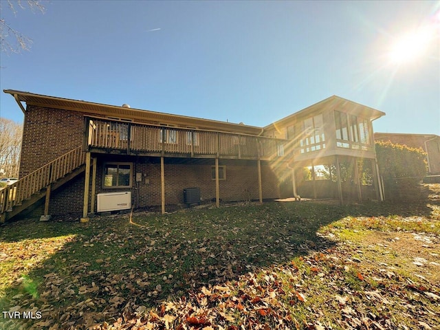 rear view of property featuring cooling unit and a deck