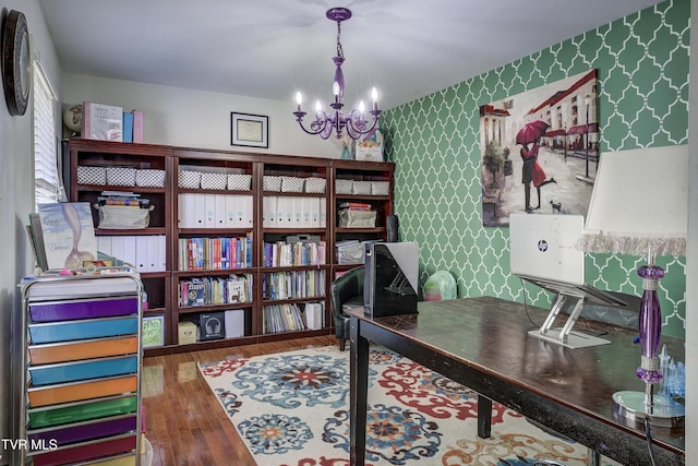 home office featuring hardwood / wood-style floors and an inviting chandelier