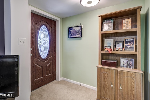 view of carpeted foyer entrance