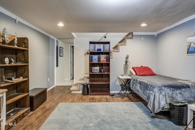 bedroom with hardwood / wood-style floors and ornamental molding