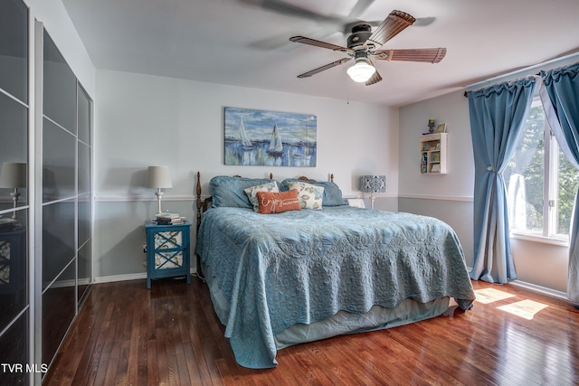 bedroom featuring ceiling fan and dark wood-type flooring