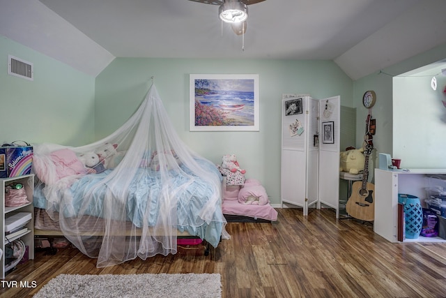 bedroom with ceiling fan, hardwood / wood-style floors, and vaulted ceiling