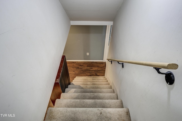 staircase with hardwood / wood-style floors