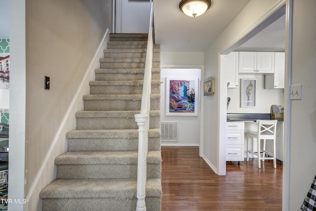 stairs featuring hardwood / wood-style flooring