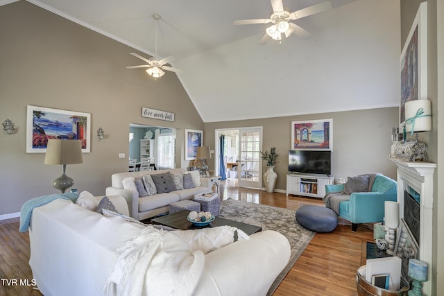 living room featuring wood-type flooring, ceiling fan, and lofted ceiling