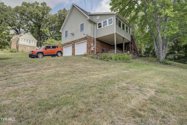 exterior space featuring a lawn and a garage