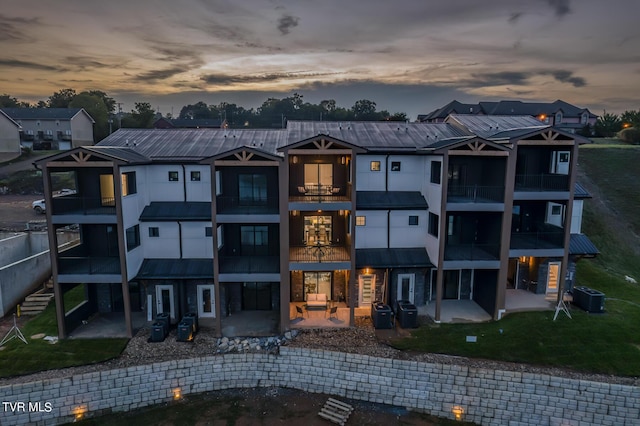 outdoor building at dusk featuring central air condition unit