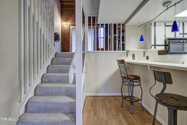 staircase featuring hardwood / wood-style flooring and a wealth of natural light