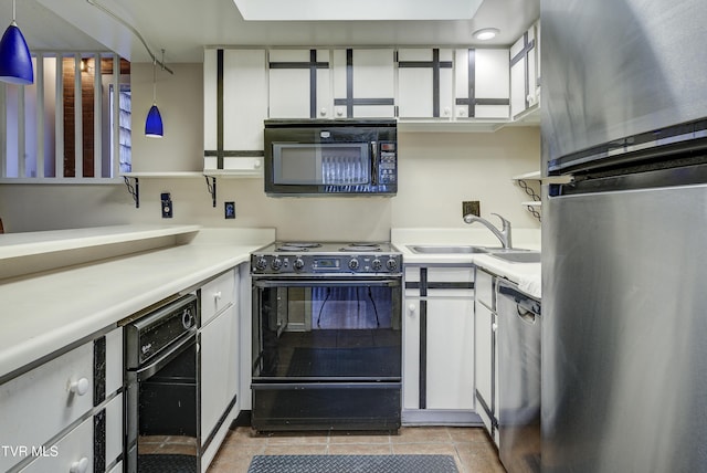 kitchen with sink, black appliances, pendant lighting, light tile patterned floors, and white cabinets