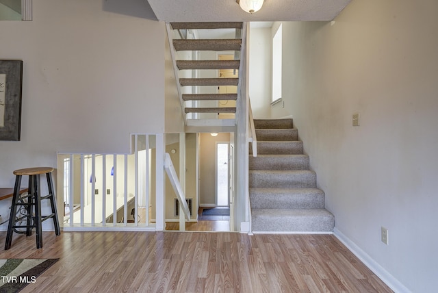 stairs featuring wood-type flooring