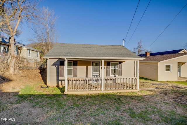 bungalow-style house with a porch and a front lawn