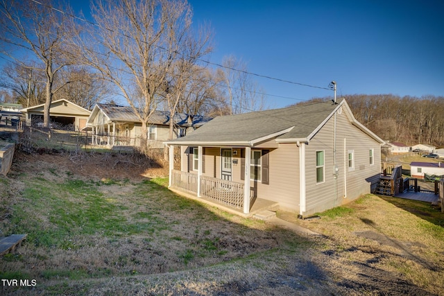 view of home's exterior with a lawn and a porch