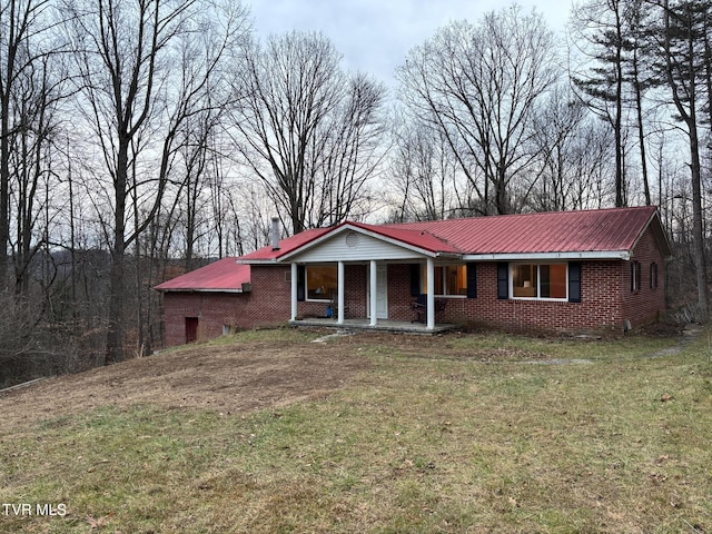 single story home featuring covered porch and a front lawn