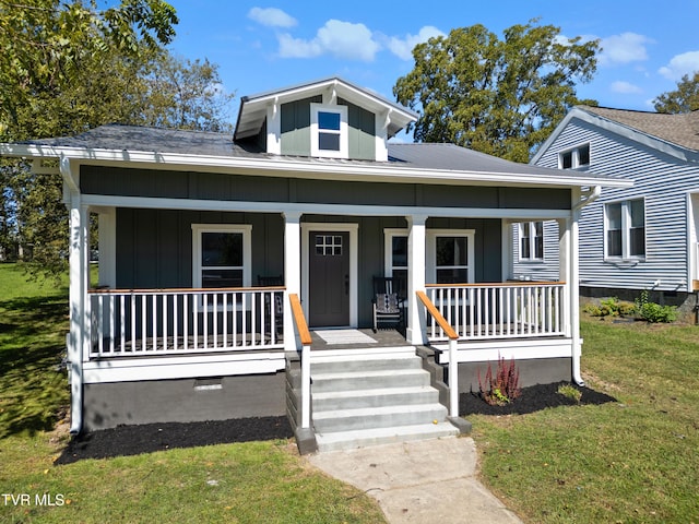 bungalow featuring a front yard and a porch