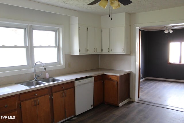 kitchen featuring dishwasher, white cabinets, sink, dark hardwood / wood-style floors, and a textured ceiling