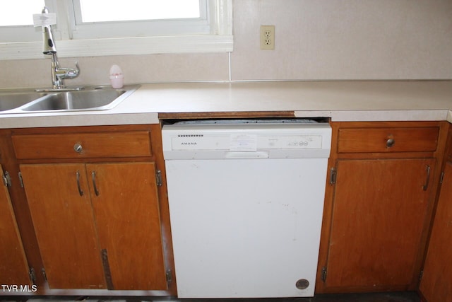 kitchen featuring white dishwasher and sink