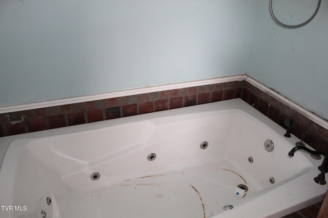 bathroom with tiled bath