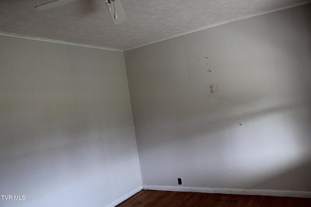 spare room featuring a textured ceiling, dark hardwood / wood-style flooring, ceiling fan, and crown molding