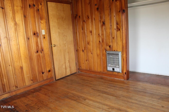 unfurnished bedroom featuring a closet, light hardwood / wood-style flooring, and heating unit