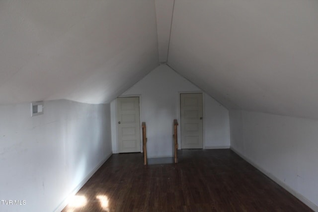 bonus room with lofted ceiling and dark wood-type flooring