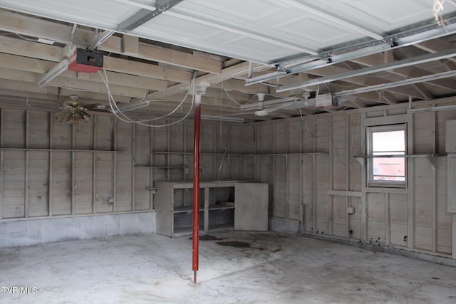 garage with a garage door opener and ceiling fan