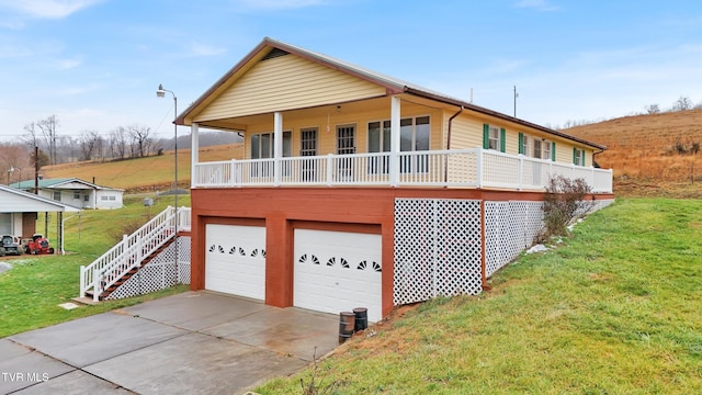 view of front of property with a garage and a front yard