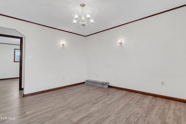 unfurnished room with a chandelier, light hardwood / wood-style floors, and ornamental molding