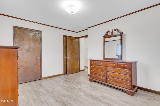 bedroom with crown molding and light hardwood / wood-style floors