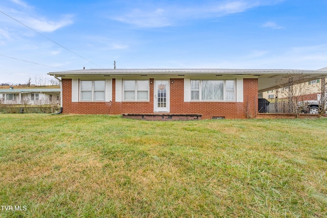 view of front of home with a carport and a front lawn