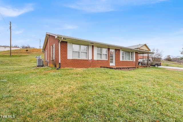 ranch-style house featuring central AC and a front lawn